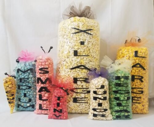 Picture of bags sizes from party favors, tiny, junior, small, regular, medium, large and extra large of gourmet popcorn.